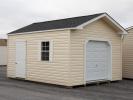 12x16 Custom Peak Storage Shed with overhead door and shelves