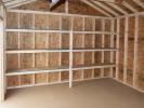 12x16 Custom Peak Storage Shed with overhead door and shelves