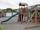 Busy Base Camp Play Set in Woodgrain Brown Vinyl with Green Slides and Swings